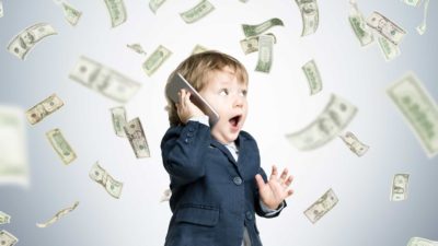 toddler in business attire surrounding by floating money representing asx shares beginner investor