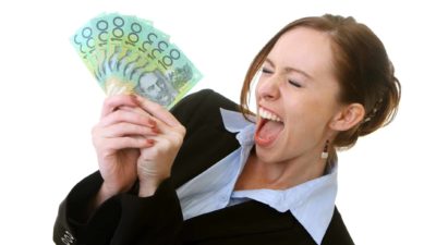 A woman looks excited as she fans out a wad of Aussie $100 notes.